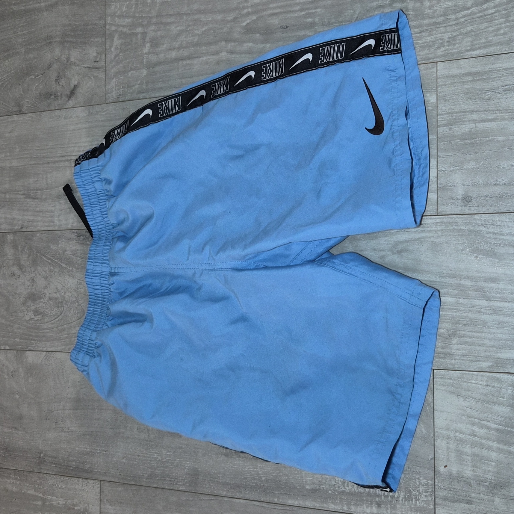 Nike Blue Athletic Shorts With Black Swoosh And Logo Tape